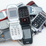 A collection of old cellphones against a white background