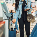 Tourists taking cash out of an airport ATM