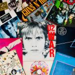Various old vinyl LP records on black background.