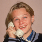 A young Leonardo DiCaprio poses for a picture while talking on a telephone, circa 1989