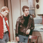 American actors Henry Winkler, as Arthur 'Fonzie' Fonzarelli, Ron Howard as Richie Cunningham, and Marion Ross as Marion Cunningham, in a scene from the television sitcom 'Happy Days', circa 1975. 