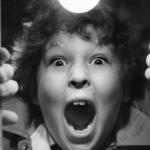 Child actor Jeff Cohen shouting through a hole in the door in a scene from the 1985 film 'Goonies.'