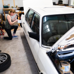 Anna Ray, a transgender woman, performs repairs on her vintage BMW