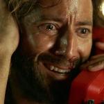Actor Henry Ian Cusick as Desmond Hume on a red phone in the 'Lost' episode titled 'The Constant.'