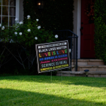 Lawn of a house in an Los Angeles suburb with a sign with messages of equality