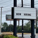 roadside "now hiring" sign