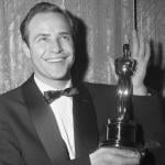 Actor Marlon Brando smiles and holds his 1954 Oscar, which he won for Best Actor in 'On the Waterfront.'