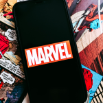 Marvel comics logo on the background of comic pages