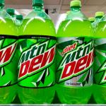 Bottles of Mountain Dew and Diet Mountain Dew on a grocery store shelf.