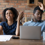 A young Black couple is expressing frustration over financial documents