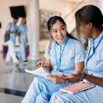 two nursing students have a discussion in a school setting