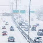 view of cars driving on freeway in both directions in blizzard conditions