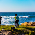 3 people playing on a golf course by the Pacific ocean at the Monterey Peninsula Country Club in Del Monte Forest, California