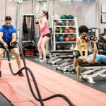 five people working out in a gym on doing different exercises