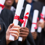 Hands of a group of graduates holding a diploma