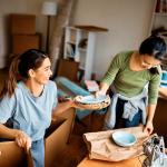 two women unpacking boxes  