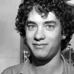A curly-haired Tom Hanks photographed in the 1980s.