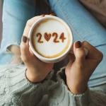 overhead view of a coffee cup with the number "2024" displayed on the foam for the new year