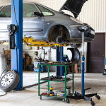 car in auto shop on hydraulic lift