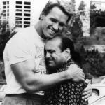 Arnold Schwarzenegger embracing Danny DeVito in a scene from the '80s movie 'Twins.'