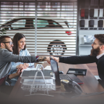 car buyers in a dealership talking to sales