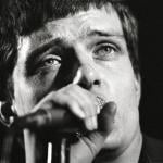 Singer Ian Curtis of Joy Division performing live onstage in 1980.