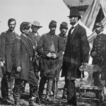 President Abraham Lincoln with General George B. McClellan at his headquarters at Antietam, October 3, 1862. From left: General George W. Morell, Colonel Alexander S. Webb, General McClellan, scout Adams, Dr. Jonathan Letterman, unidentified officer, President Lincoln, Colonel Henry Hunt, General Fitz, John Porter, unidentified officer.