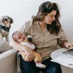 parent juggling pet and baby while working from home
