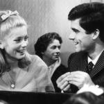 Actors Catherine Deneuve and Nino Castelnuovo share a laugh in a scene from the 1964 film 'The Umbrellas Of Cherbourg.'