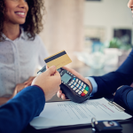 credit card transaction and man and woman renting a car in background