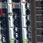 aerial view of line of ubers waiting to enter rideshare lot