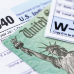 1040 and W-2 tax forms, with U.S. treasury check