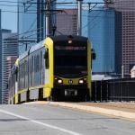 LA Metro E line train pulls into Boyle Heights with Downtown LA in the background