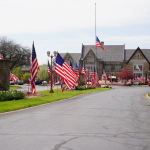 American flags waving at Wisconsin Memorial Park cemetery in Brookfield, Wisconsin to honor and celebrate fallen soldiers and veterans of United States wars for Memorial Day.