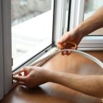 A worker installing energy-efficient windows in a home.