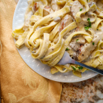 Italian fettuccine alfredo pasta dish with grilled chicken breast