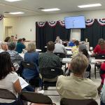 County judges and election workers gather in a full room for the Republican canvass of the primary election.