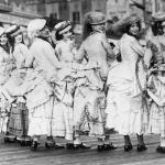 A group of women dressed in bustle gowns on the boardwalk in the 1890s.