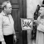 American actor Jean Stapleton (right) points a toy gun with a flag that reads, 'Bang,' at American actor Carroll O'Connor (1924 - 2001), in a still from the season premiere of the television series 'All in the Family'. 