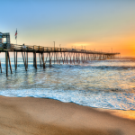 A pier in the Outer Banks of North Carolina at sunrise.