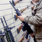 Man with an automatic rifle at the store.