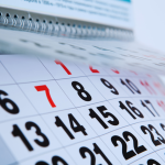 A calendar with red and black dates.