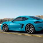 A Miami blue Porsche 718 Cayman on the road.