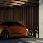 An orange electric car at a charging station.