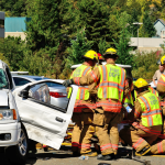 Firefighters extricate victims of a two vehicle t-bone accident at an intersection
