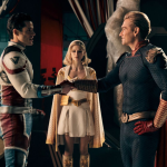 Supersonic (Miles Gaston Villanueva) and Homelander (Antony Starr) shake hands as Annie January (Erin Moriarty) watches in a scene from 'The Boys'