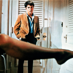 American actor Dustin Hoffman as Benjamin Braddock, watching his older lover Mrs Robinson get dressed in a promotional still from the film 'The Graduate', 1967.