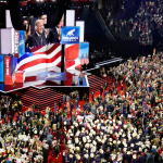 Donald Trump is shown on the Jumbotron at the Republican National Convention with a bandage on his right ear following an assassination attempt the weekend prior.