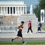 A man jogs near the National World War II Memorial and Lincoln Memorial on the National Mall in Washington, DC.