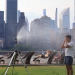 Sprinklers help people cool off during the hot days as temperatures climb to over 100 degrees in Long Island City, New York on June 21, 2024.